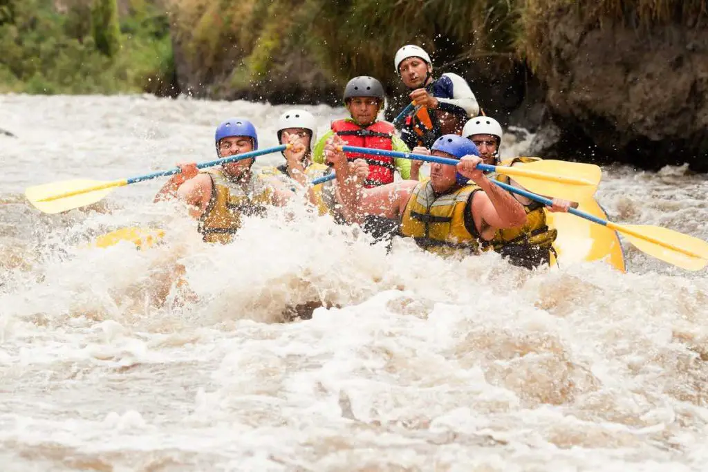 Group of powerfull young men on a rafting boat. 