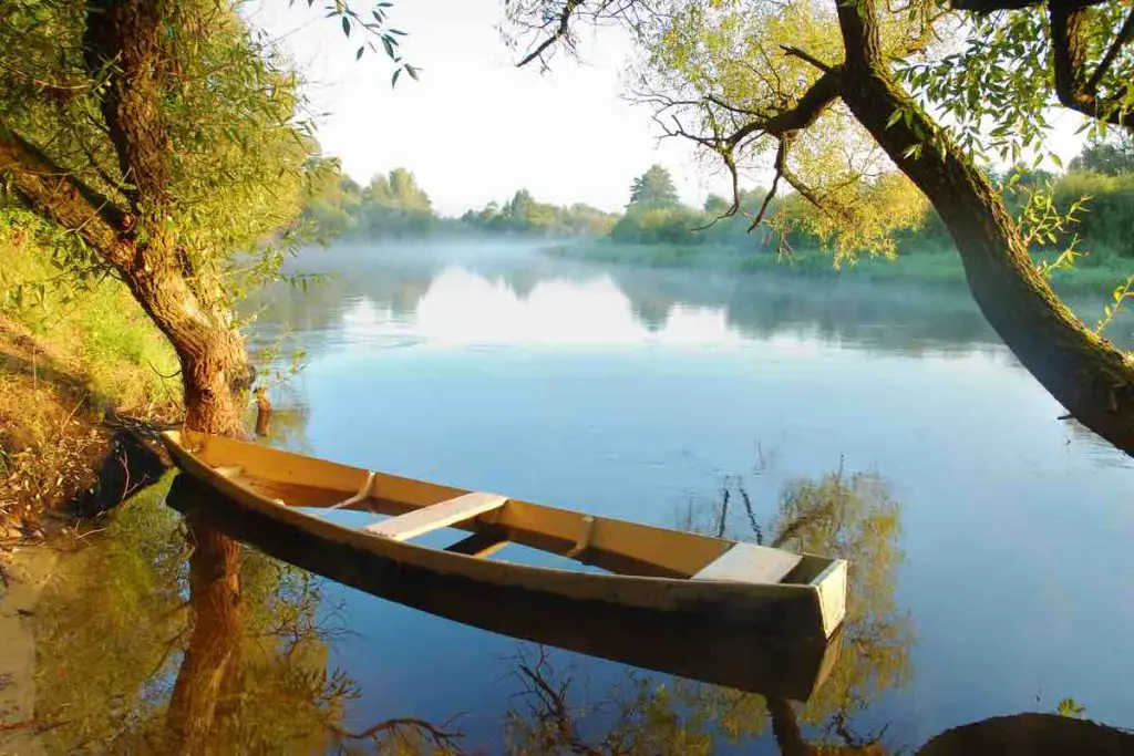 Beautiful autumn river and yellow rowing boat on a tranquil early morning