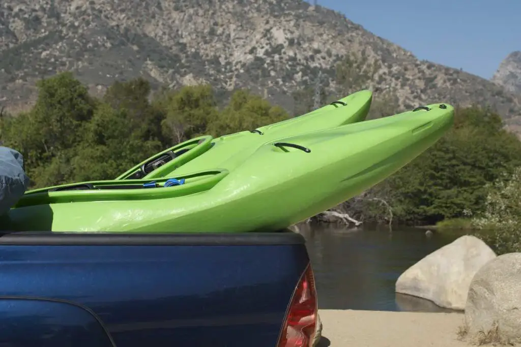 Two kayaks in pick-up truck