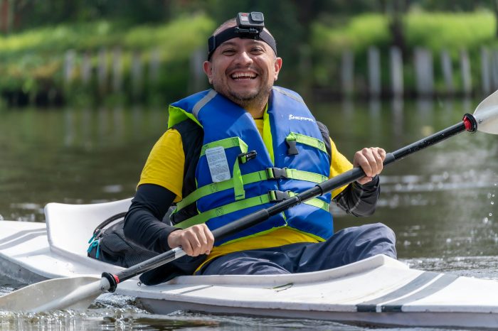 Smiling kayaker enjoying outdoor adventure in CDMX, capturing the joy of water sports.