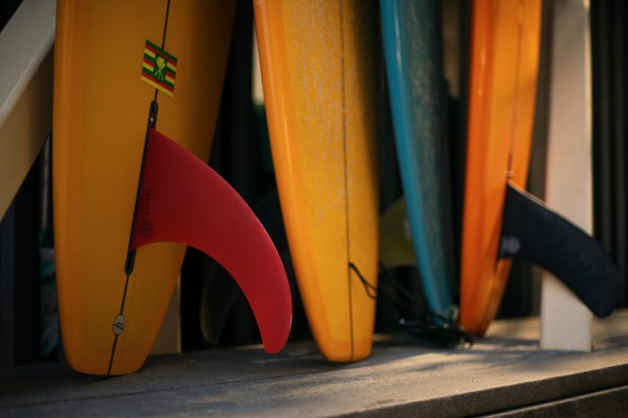 A close-up of vibrant surfboards with fins ready for summer fun in Honolulu, HI.