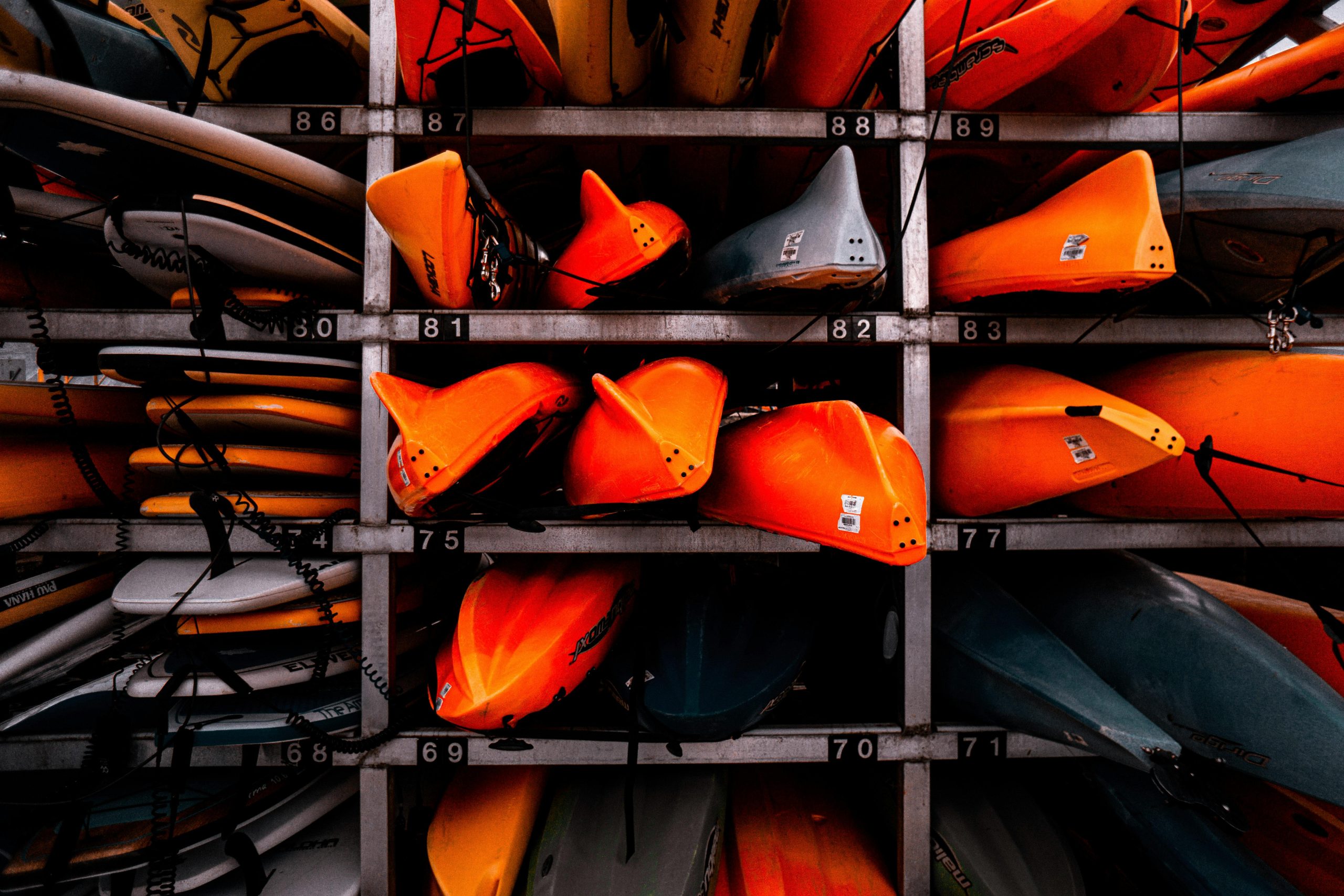 Colorful stacked kayaks in a storage rack, creating a vivid display in Vancouver.